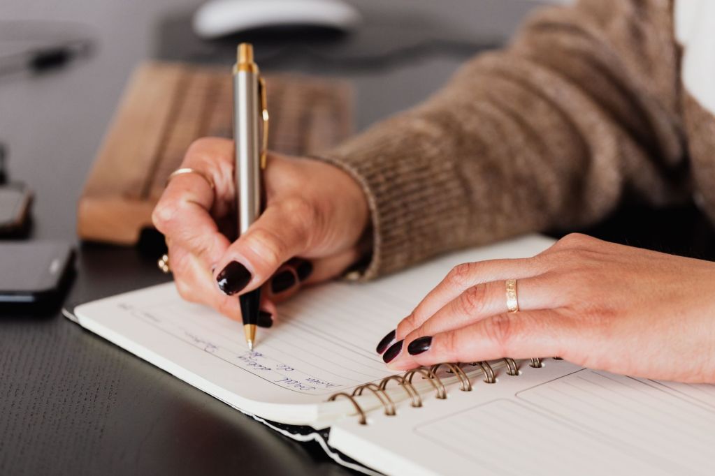 Woman editor writing a developmental edit letter for indie author.